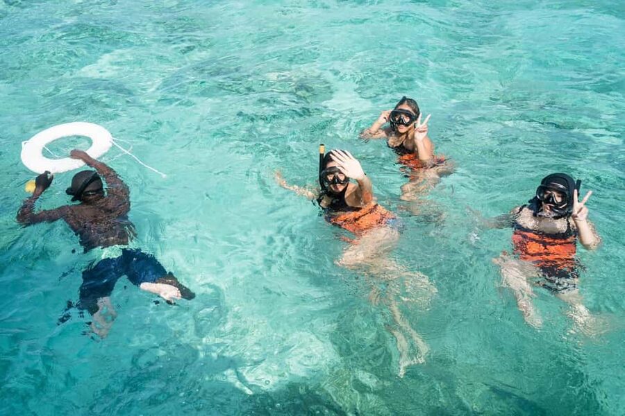 Punta Cana: Catamaran Tour with Reef Snorkeling and Open Bar - Boarding a spacious boat with a lively crew